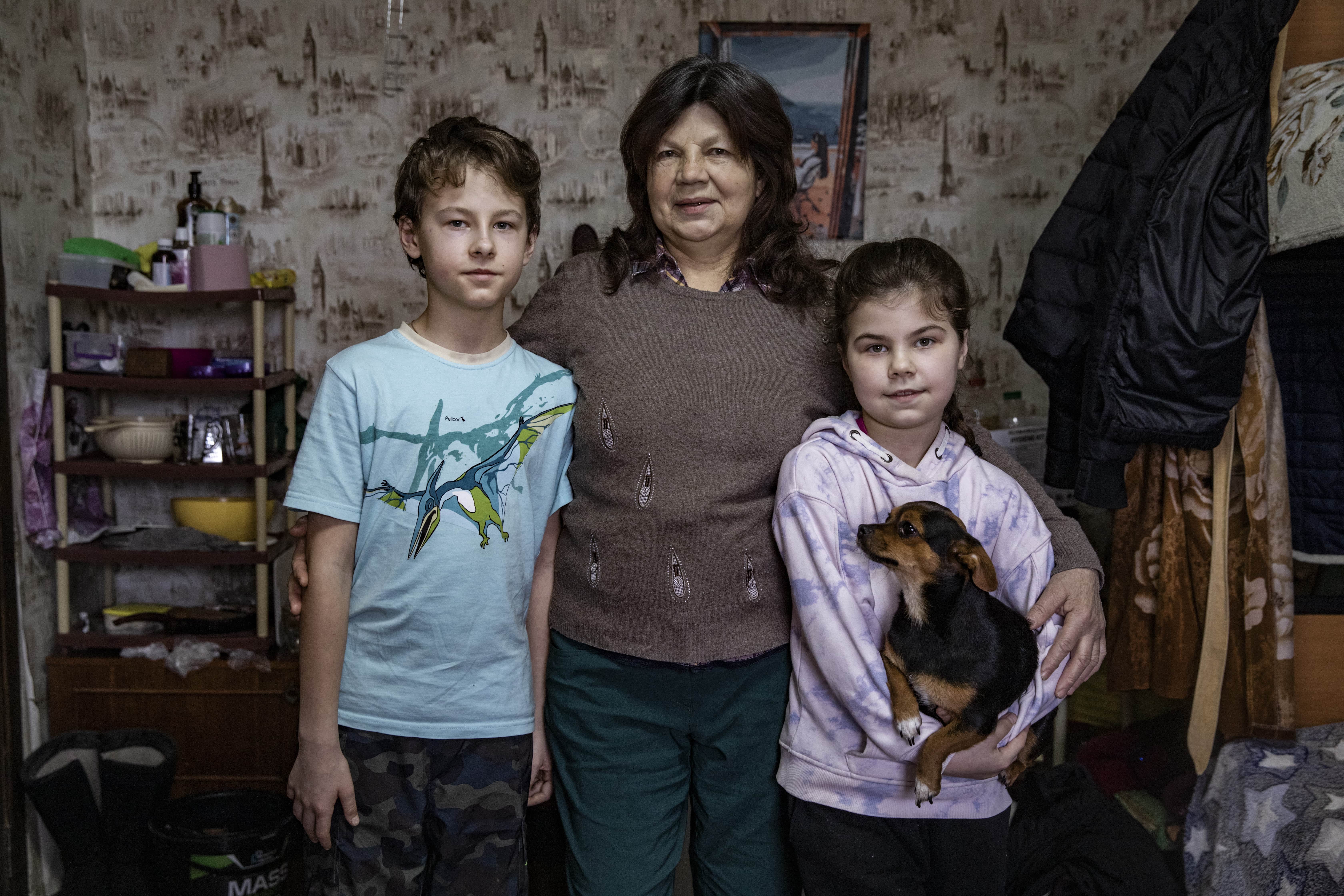 Tamara and her grandchildren inside their home at a centre for displaced Ukrainian families. 