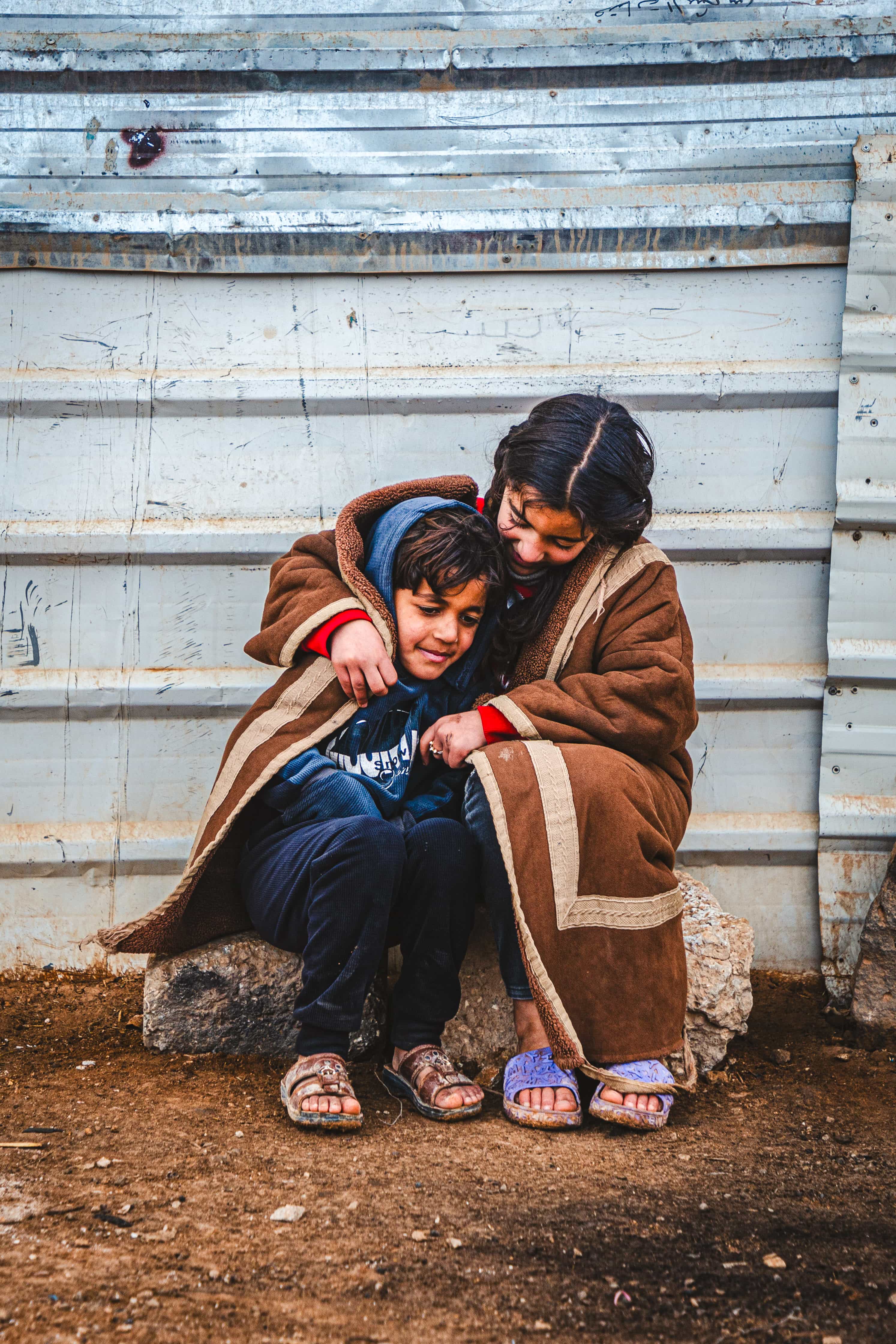  Batool Ali, 9, and her brother Abdulaziz, 7, Syrian refugees, huddled close to stay warm in Za’atari Refugee Camp