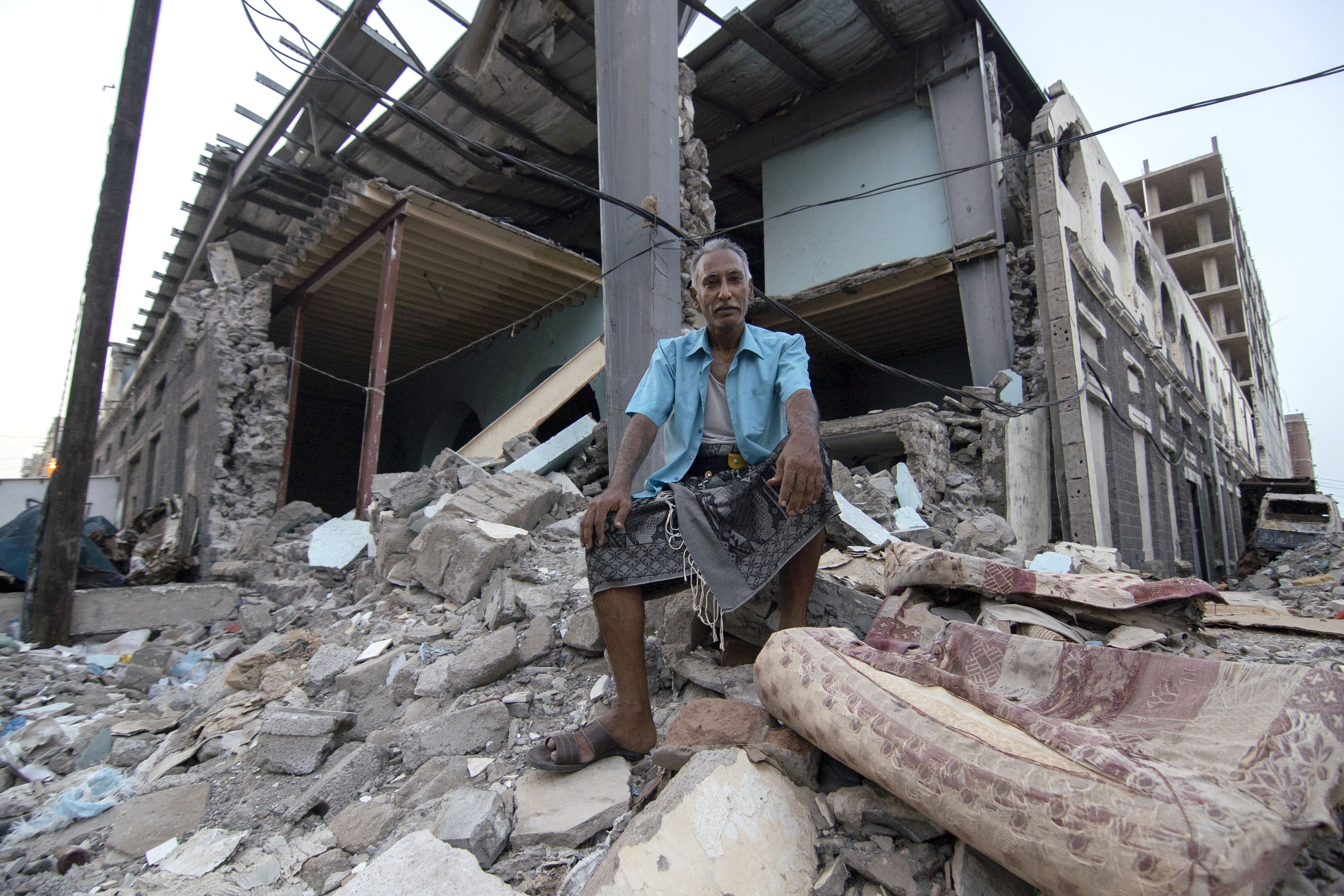 Shaker Ali, 52, sits in front of what used to be a marketplace in Aden.
