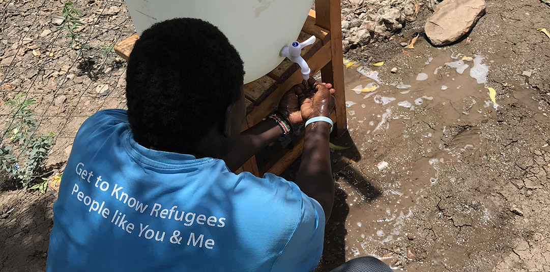 A refugee washes his hands at Kakuma refugee camp in Kenya