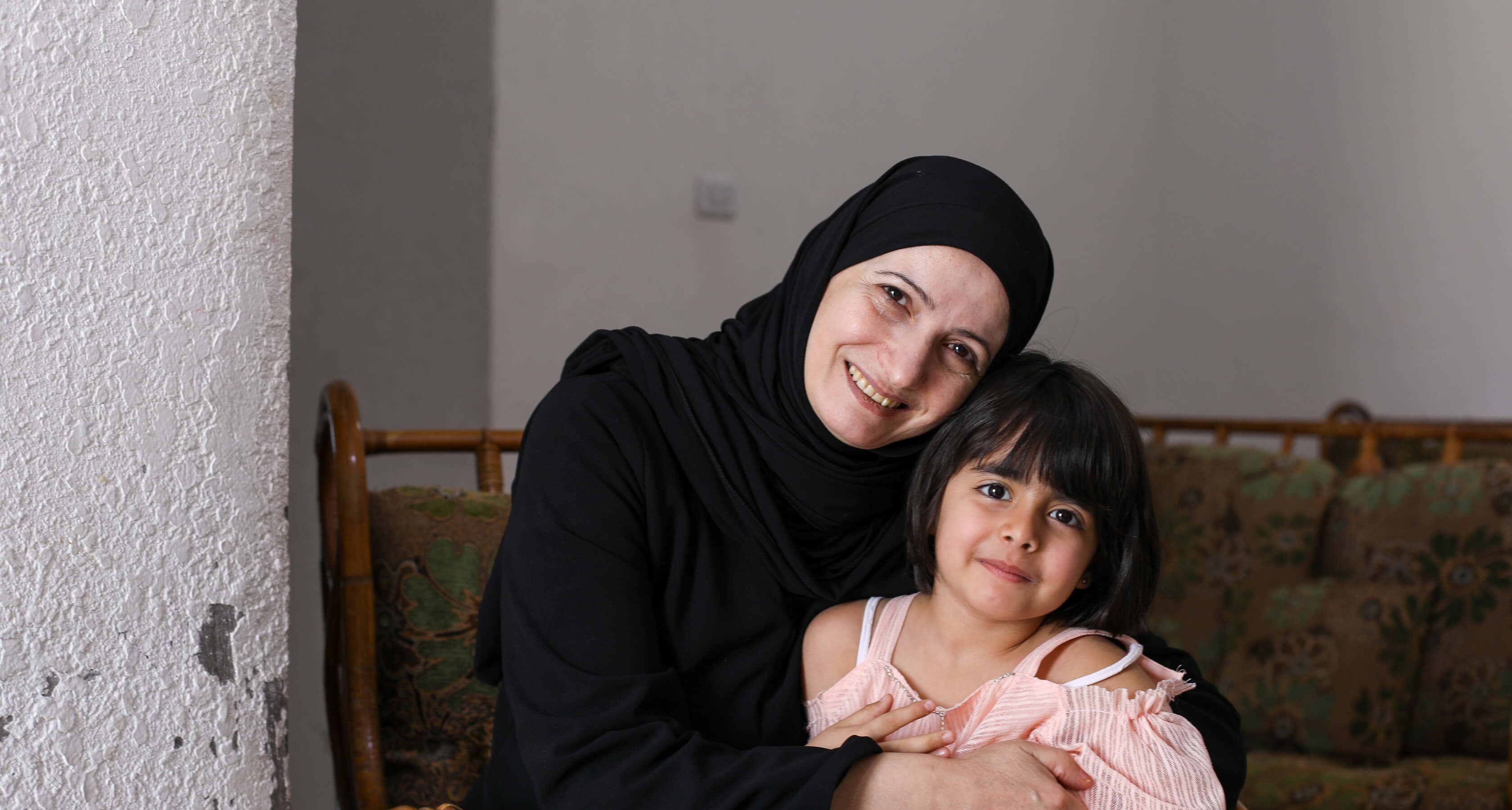 Ghada, a Syrian refugee and entrepreneur is pictured at home with her youngest daughter Sham, 4.
