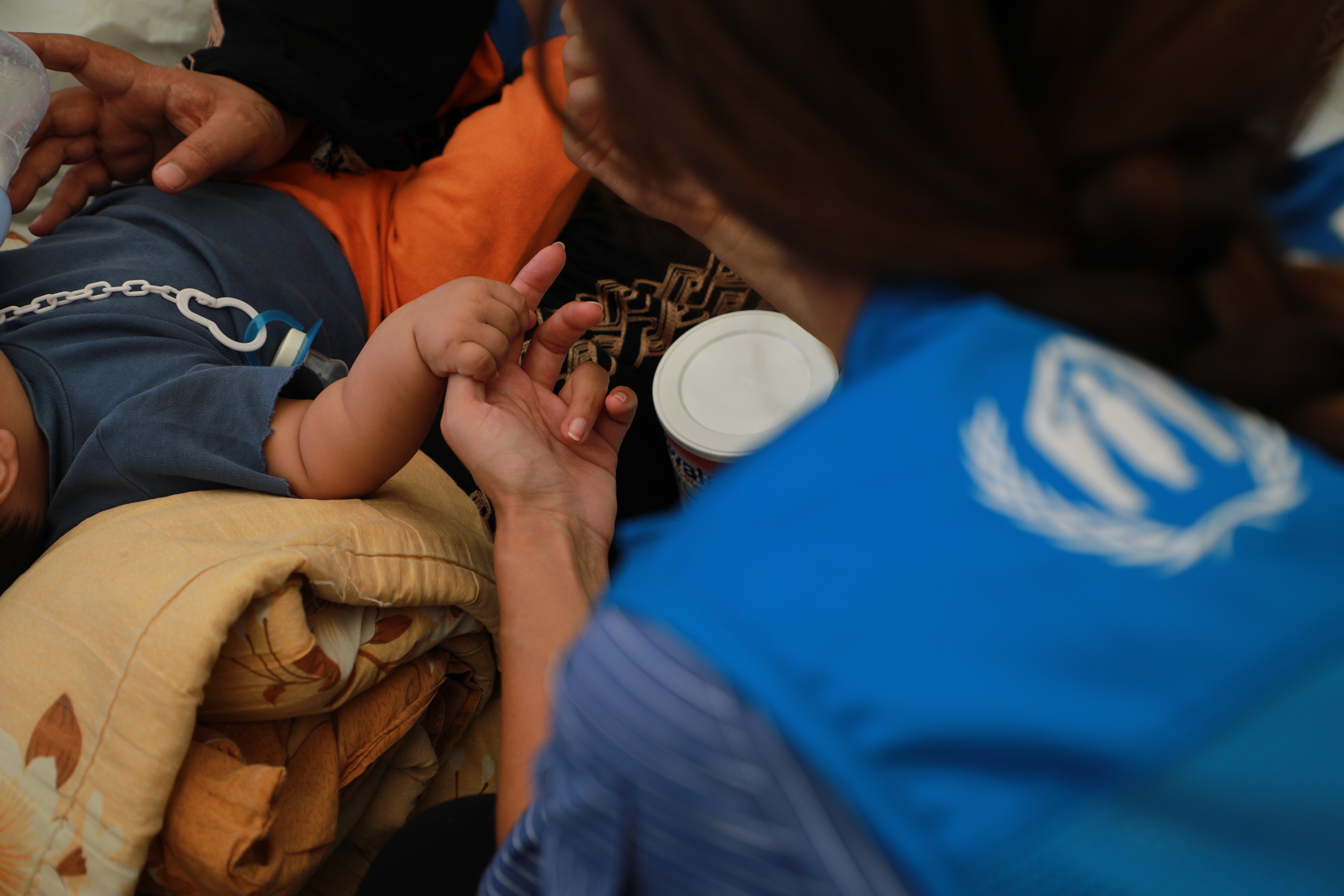 A UNHCR worker assists a child in Lebanon