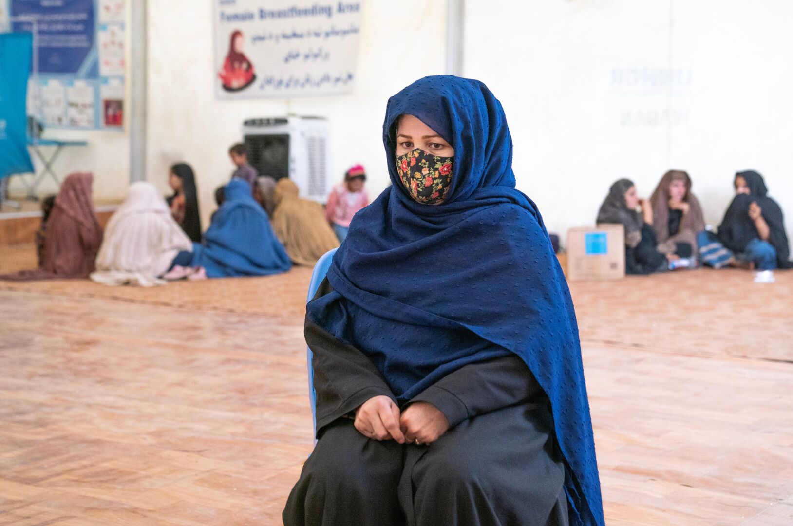 Asma waits for assistance at a UNHCR aid centre. UNHCR is on the ground, helping people deported or forced to return from Pakistan and Iran.