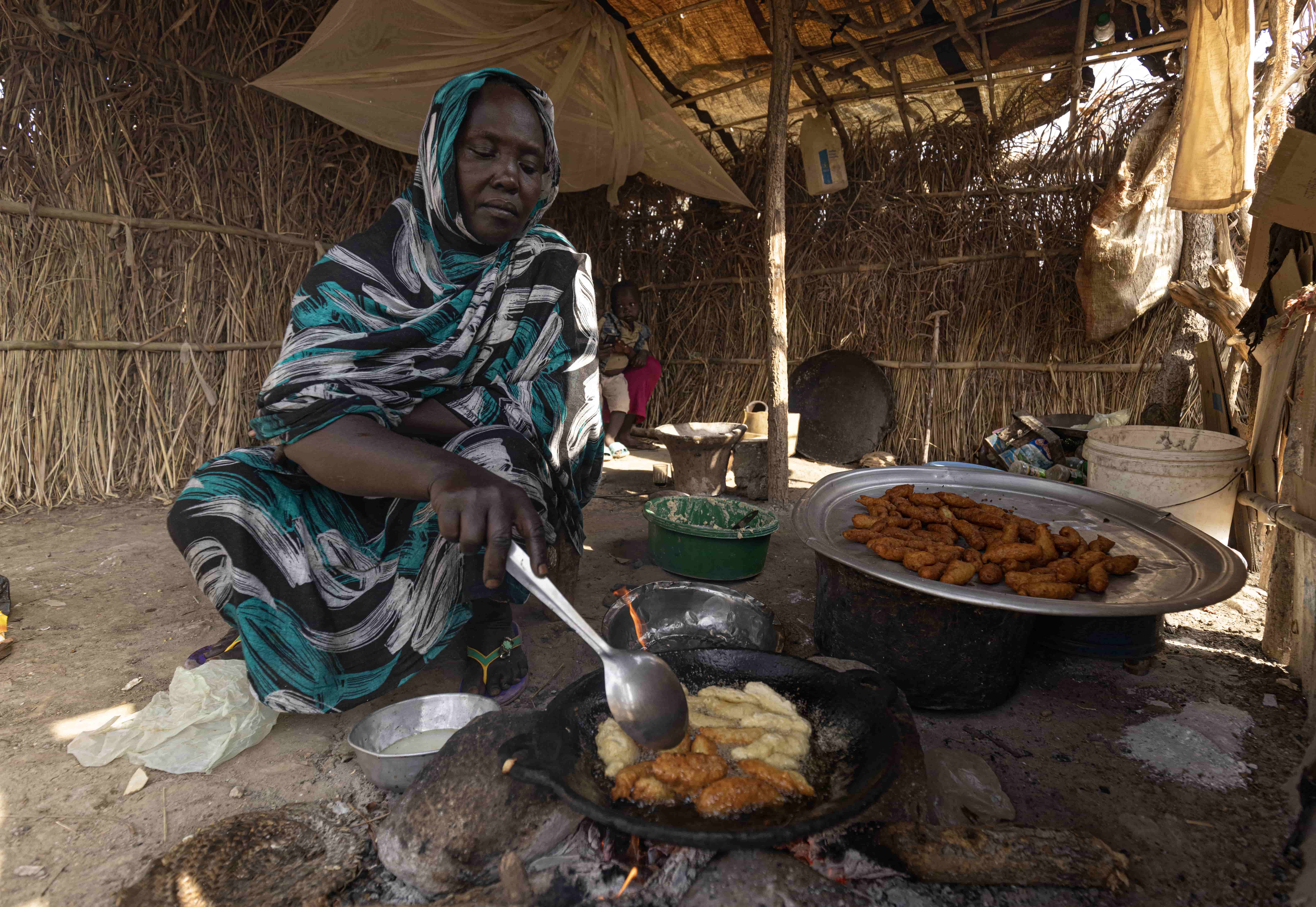 Hawa cooks falafel which she sells to buy soap and food for her children, Ethiopia