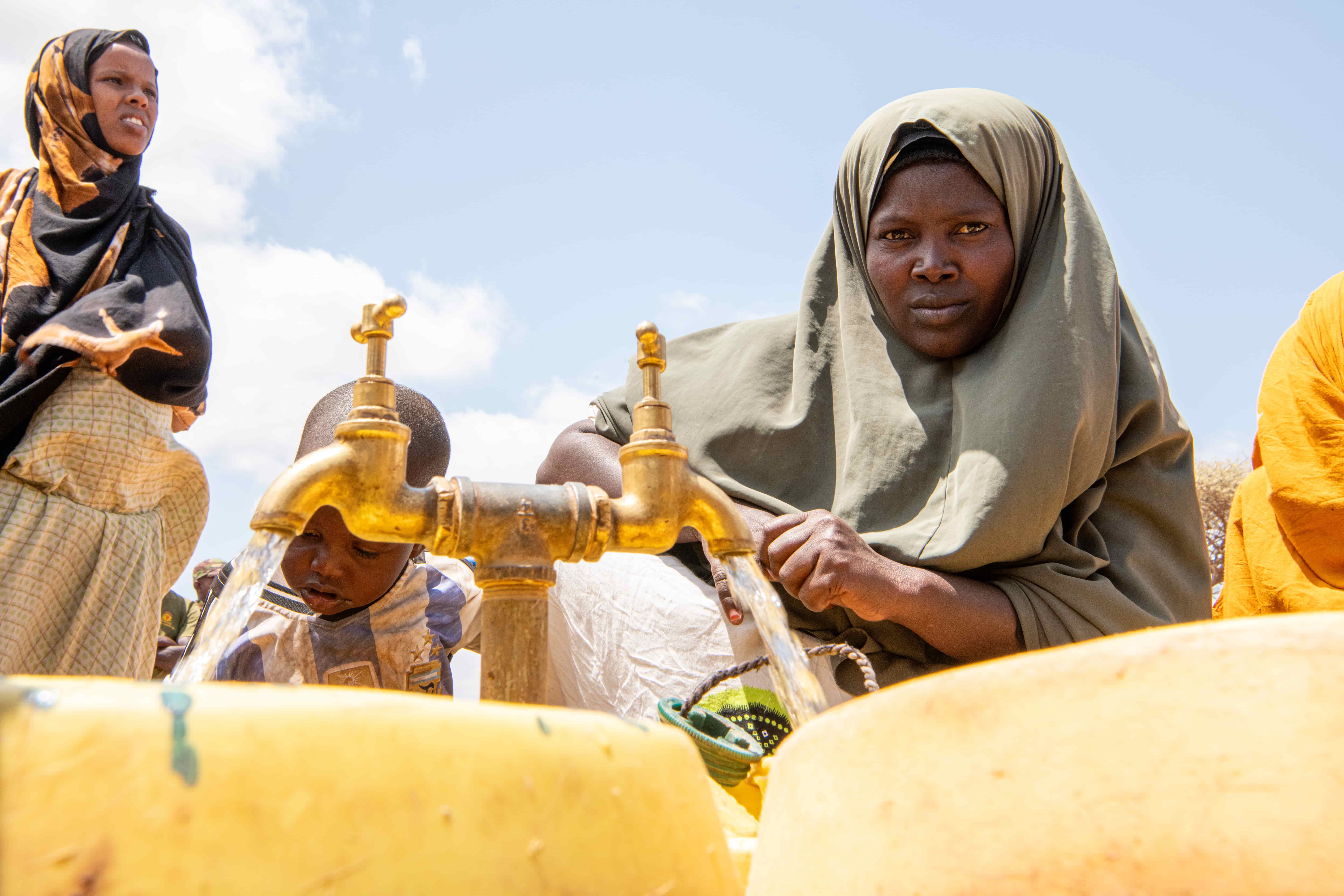 Hajira Abdullaji fetches clean water together with other newly arrived Somali refugee women and girls in Dagahaley camp