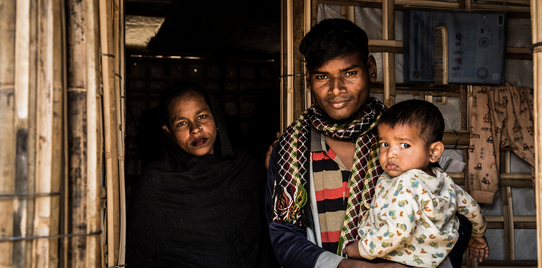 Rohingya refugee, Abul Kalam holds his 17-month-old baby, Arafat and stands next to his wife Rahima in Kutupalong settlement. © UNHCR/Vincent Tremeau